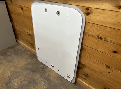 Kubota SSV65 and SSV75 skid steer clear polycarbonate windshield replacement panel against a wood wall