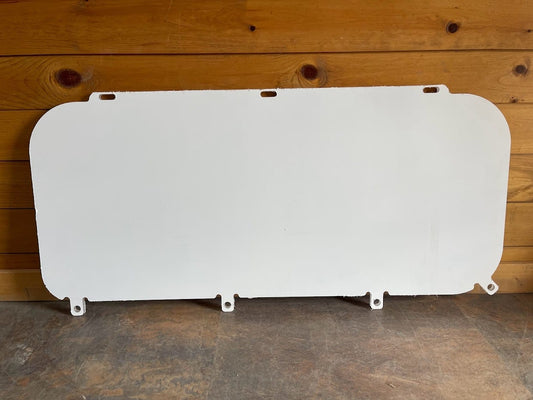 Kubota SVL polycarbonate side window panel with protective film, leaning against wooden background