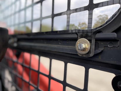 Close-up of bolt and metal retaining hardware securing Kubota SVL polycarbonate side window panel in cab frame