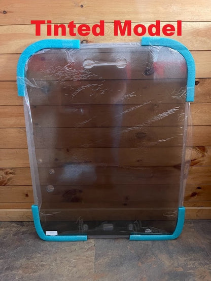 Kubota SVL tinted polycarbonate windshield in protective wrap with blue foam corner protectors, labeled Tinted Model