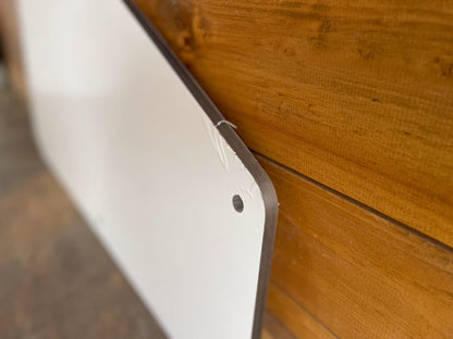 Close-up of diagonal cut edge on Kubota SVL upper polycarbonate side window panel with mounting hole detail