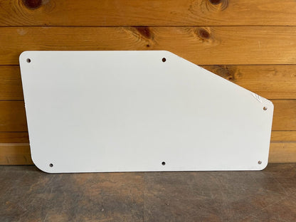 Kubota SVL upper polycarbonate side window panel with protective film, showing diagonal-cut shape and mounting holes