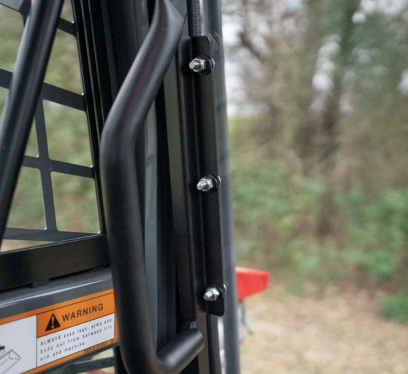 Close-up of steel mechanical fastening bolts on Takeuchi TL8R2 windshield door frame