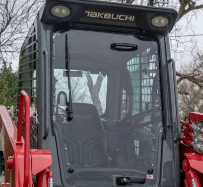 Takeuchi TL8R2 cab with polycarbonate windshield installed, front view showing full door panel