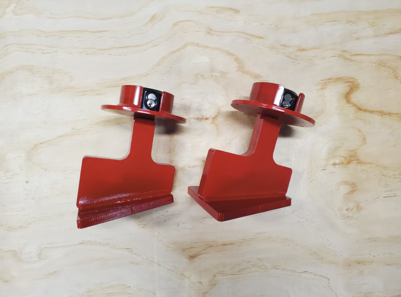 Two Trac-Lock anti-theft devices shown from the side, displaying the mounting bracket base