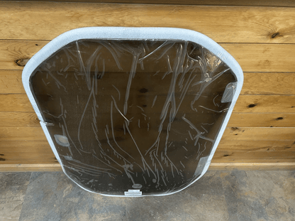 Rear view of a Wacker Neuson ST/SW tinted polycarbonate windshield showing the white rubber frame and back surface