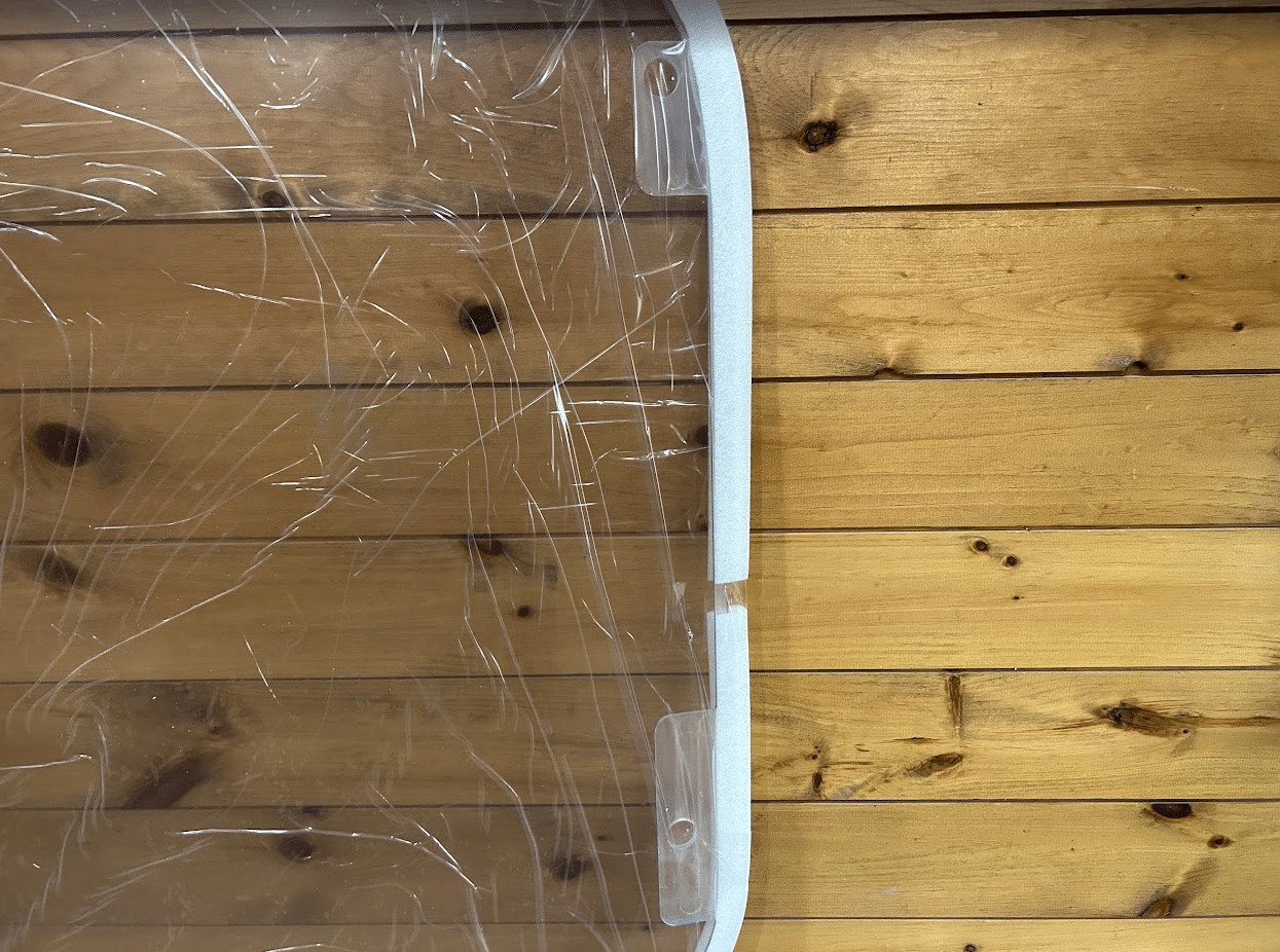 Close-up of white aluminum frame corner on Wacker Neuson ST/SW polycarbonate windshield replacement