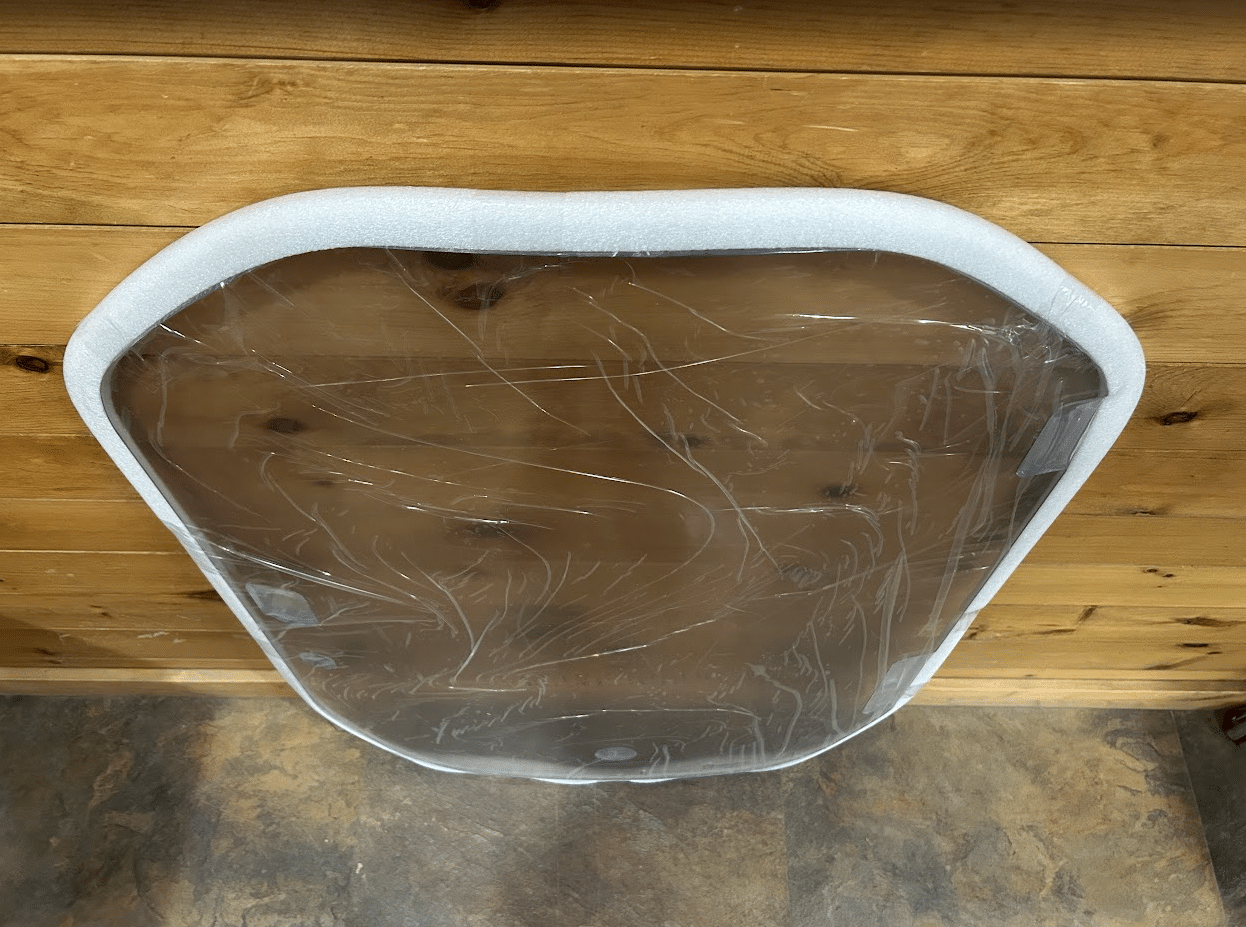 Top view of Wacker Neuson ST/SW polycarbonate windshield showing curved shape and white rubber door seal